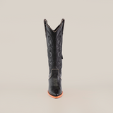 The Linda Studs Tall Shaft Black boot from the Platinum Collection is presented on a neutral background, showcasing intricate decorative stitching, a pointed J toe, and a wooden sole with elegant swirling patterns.