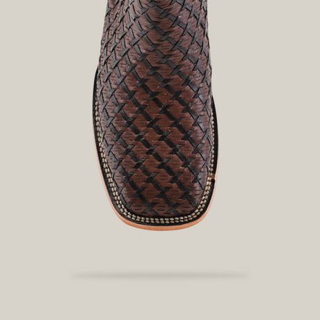 Close-up of the Basket weave BlackBrown Square Toe cowboy boot, displaying an intricately woven leather design on the toe. This artisan-crafted boot highlights exquisite craftsmanship and edge stitching—a true testament to cowboy fashion.