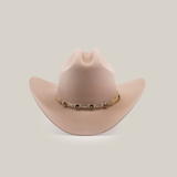 The 6X Sinaloa Belly is a light brown cowboy hat made from sheeps wool, featuring a wide brim and a decorative band with metal accents. It embodies Western heritage against a plain white background.