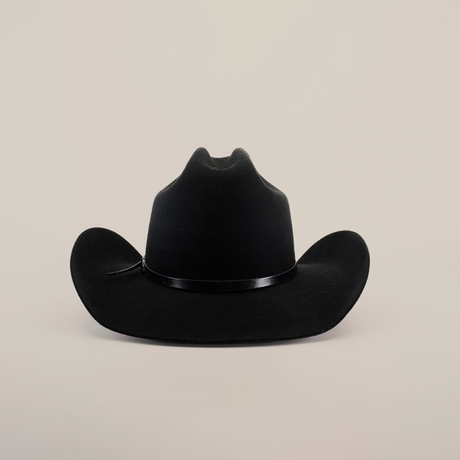 The 6X Leandro Black is a luxurious cowboy hat crafted from sheeps wool, featuring a wide brim and slightly curved shape. It rests elegantly on a plain white background, adorned with a thin black band around the crown.