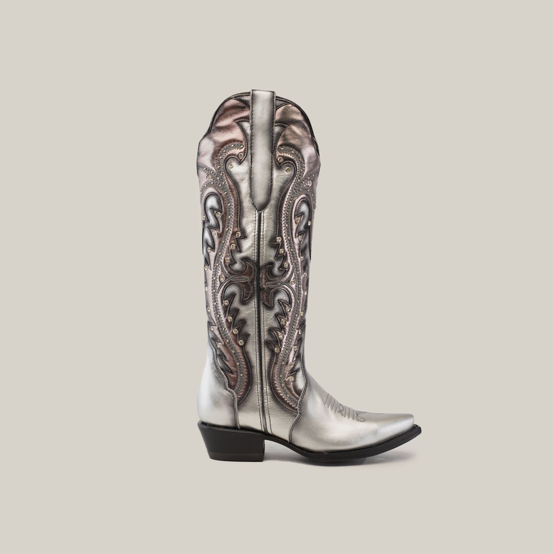 The Valentina Silver - Tall Shaft - Snip Toe cowboy boot is made from premium leather, featuring intricate swirling patterns and a pointed toe on a plain gray background.