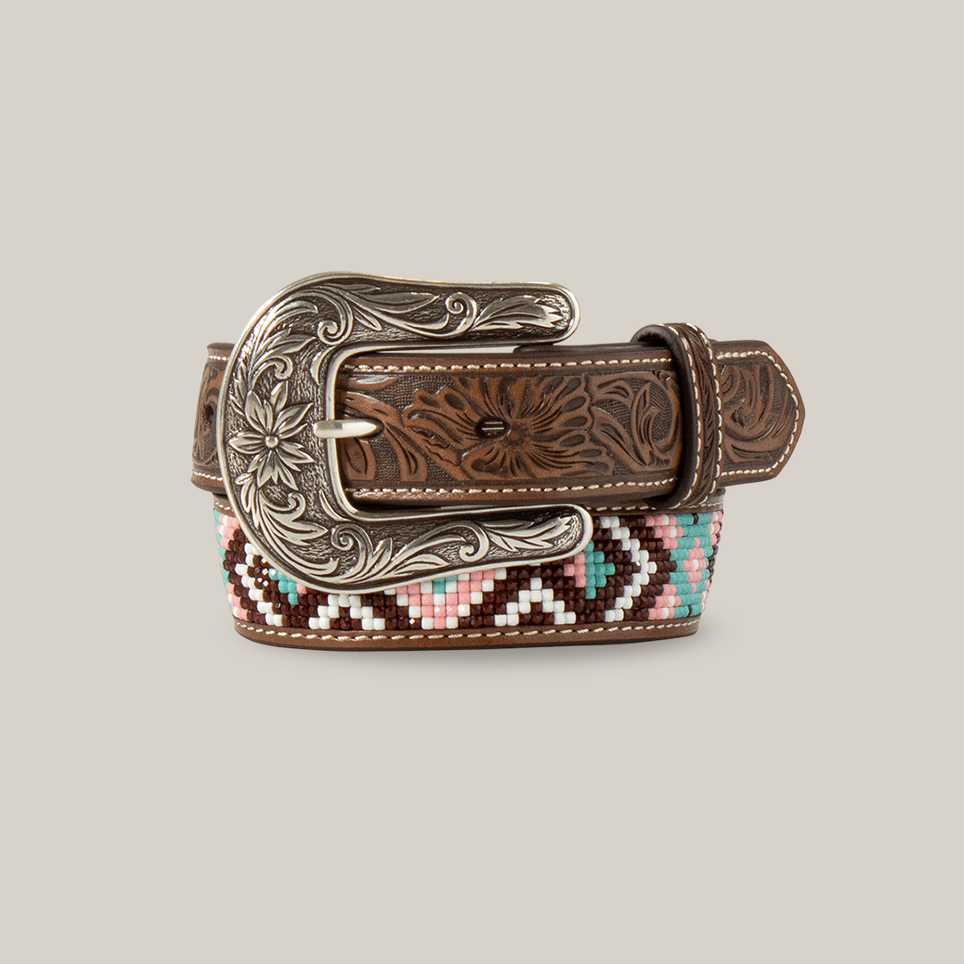 The Angel Ranch Western Belt Girls Beaded Inlay Embossed Billet - D130004497 features intricate floral engravings on the silver buckle and strap, with a colorful beaded geometric pattern in pink, turquoise, brown, and white on the underside, capturing Western-inspired designs.