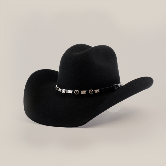 The 6X Chihuahua Black is a premium black cowboy hat crafted from high-quality Chihuahua felt, featuring a wide brim and a decorative band with small silver conchos and intricate designs, all set against a white background.