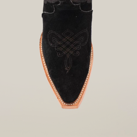 Close-up of the snip toe on an Amara Black Suede - Tall Shaft boot, showcasing intricate stitching on the vamp. The pointed toe boot has a light brown sole with visible stitching, set against a plain white background.