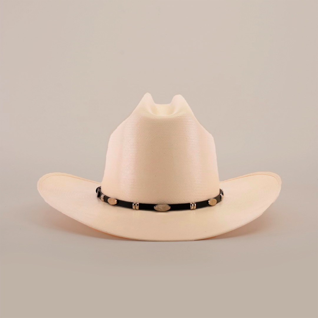 The 1000X Dos Carnales Straw Hat is a white cowboy hat with a wide brim and a black band adorned with silver conchos, crafted with exceptional quality. It stands out against a light background, proudly showcasing its superior craftsmanship.