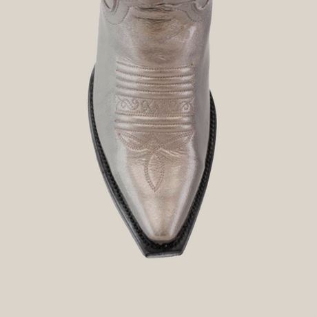 A top view of the Taylor Mercury - Tall Shaft - Snip Toe cowboy boot in silver shows intricate toe stitching. With its classic leather sole, the boot is set against a simple light background, emphasizing its detailed design.