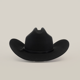 A Western classic, the 6X Country Black is a wide-brimmed cowboy hat with a smooth texture and creased crown, crafted from fine sheep wool felt and set elegantly on a plain white background.