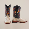 The Exotic American Alligator Patchwork Bone Square Toe cowboy boots flaunt a square toe and intricate red, orange, and beige tribal patterns on a black shaft. Its foot area displays textured design with light colors and patchwork details, completed with a wooden heel and sole.