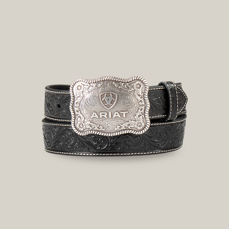 The Mens Ariat Black Embossed Plate Buckle Belt - A1020401 blends Western heritage with rugged elegance, featuring a black leather design with an embossed floral pattern and a large decorative silver buckle engraved with the ARIAT brand and shield logo.