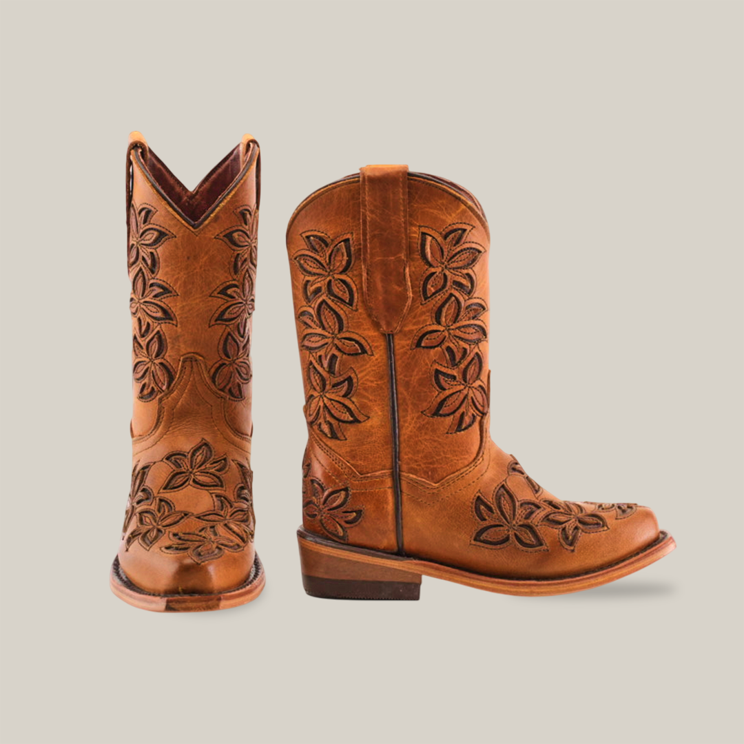 The Cosala Honey - Snip Toe boots showcase genuine leather craftsmanship, featuring a snip toe design and floral embroidery. One boot faces forward while the other turns to highlight the intricate stitching, capturing an authentic western style.