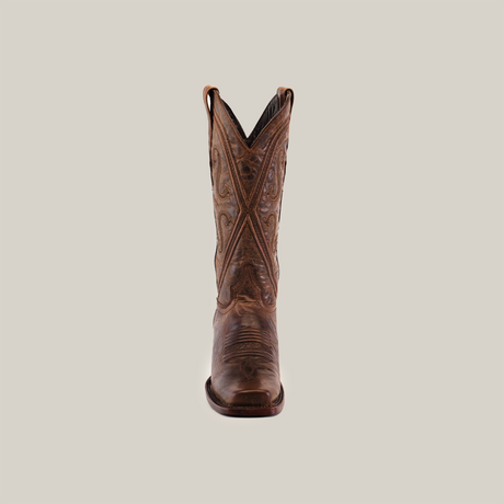 A Piola Tabaco - Mid Shaft - Narrow Square Toe boot, crafted from high-quality leather, stands centered against a white background. Intricate stitching showcases its craftsmanship, featuring curved patterns on the shaft, adding to its rustic, traditional look.