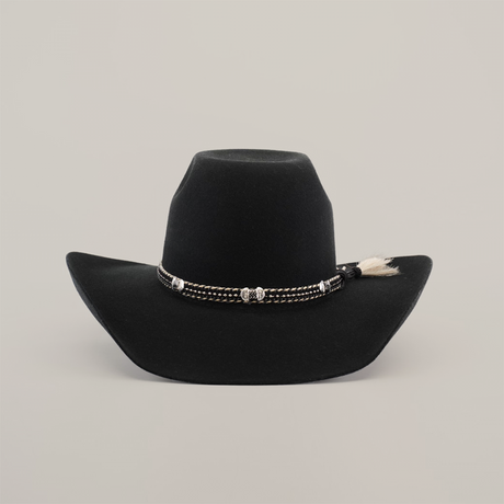 The 6X Brazil Black cowboy hat features a wide brim, crafted from Brazil felt. Its adorned with a braided band accented with silver and a small tuft of sheep wool on the side, and is set against a plain white background.