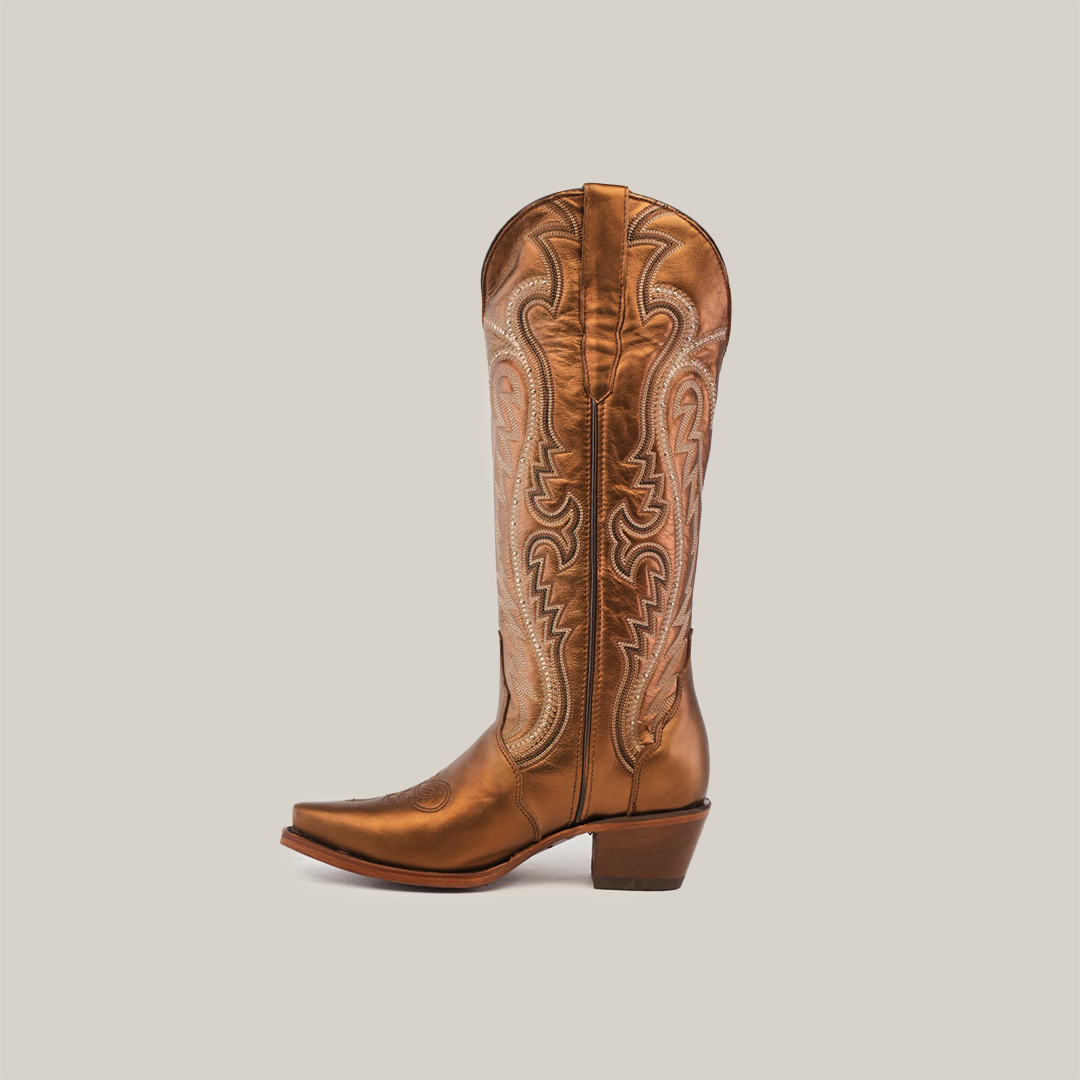 The Nihan Copper, a single brown cowboy boot with intricate stitching, showcases traditional craftsmanship. It features a snip toe, medium-height heel, and tall shaft against a plain light gray background, representing the finest in handcrafted excellence.