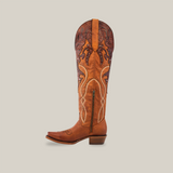 The Miriam Brick - Tall Shaft - Snip Toe is a tall brown leather cowboy boot featuring intricate embroidery and decorative patterns on the upper shaft. Crafted from premium materials, it includes a side zipper and low heel, set against a plain white background.