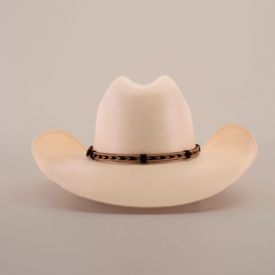 Set against a plain backdrop, the 5000x Chihuahua Straw Hat displays its fine craftsmanship with a light-colored wide brim and a decorative brown band encircling the crown.