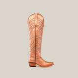 The Taylor Rose Gold features a single tan leather cowboy boot with intricate stitching, a snip toe, and stacked wooden heel. Its tall shaft stands upright on a white background, highlighting its elegant craftsmanship.