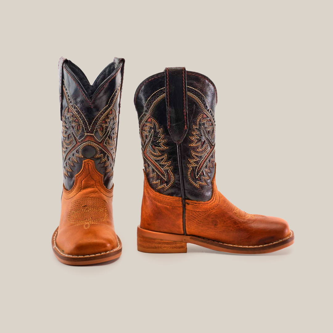 Showcasing a side and front view, the Cater Honey Square Toe boots are handcrafted with brown cowhide leather feet and dark shafts featuring intricate stitching. With rounded toes, stacked heels, and pull straps on the sides, these boots exude classic Western charm.