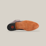 Bottom view of the Napa Wine - Round Toe shoe reveals a tan sole with fine craftsmanship, featuring a stitched outline, small black rubber heel with red circular detail, and partially visible embossed text exemplifying calidad excepcional.