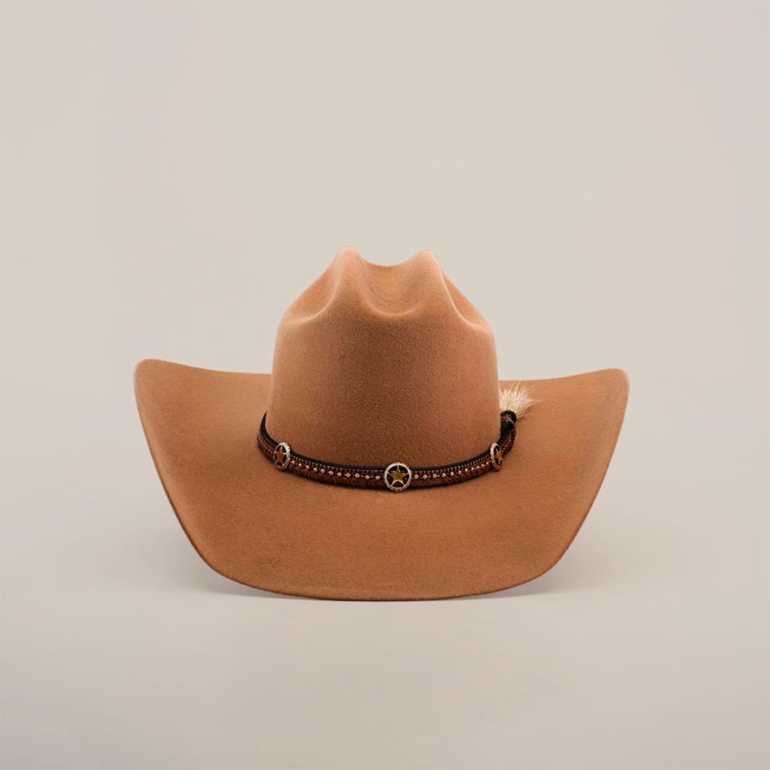 The 6X Doble SS Fawn is a brown felt cowboy hat with a dark leather band, decorative conchos, and a small feather on the side, displayed on a plain white background.