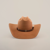 The 6X Doble SS Fawn is a brown felt cowboy hat with a dark leather band, decorative conchos, and a small feather on the side, displayed on a plain white background.