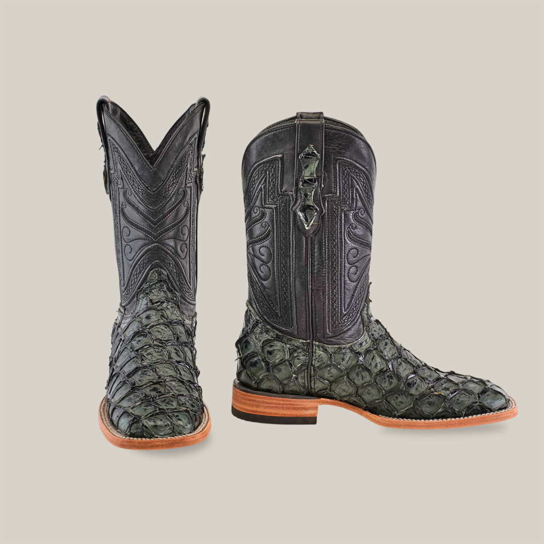 The Exotic Piraruco Fish - Charcoal boots, cherished by fashion lovers, showcase intricate stitching and greenish fish leather scales on the lower part. Featuring wooden soles and a tall, pointed shaft with decorative patterns, they contrast vividly against the plain white background.