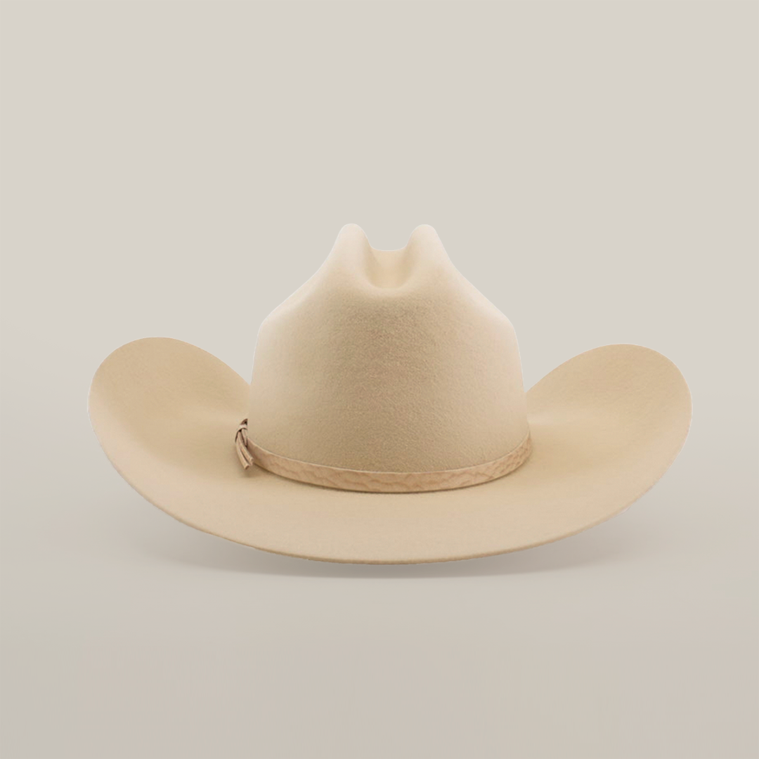 The 6X Country Bone is a classic Western-style tan cowboy hat with a wide brim and crease, crafted from fine felt. It features a light brown band around the base and is showcased on a plain white background.