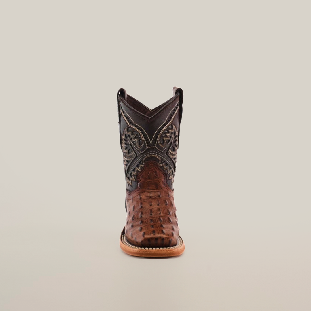 The Caiman Hornback Print Chocolate Square Toe cowboy boot is set against a white background, highlighting its exquisite leather craftsmanship with intricate stitching on the dark upper and a brown textured lower section, complete with a wooden sole, epitomizing authentic Western style.