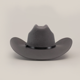 The 6X Bull Oxford is a wide-brimmed, dark grey felt hat with a black band, shown front-facing on a white background. This luxury western wear piece boasts a slightly curved brim, epitomizing timeless western style.