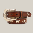 The Ariat Girls Brown Leather Horse Concho Western Belt (A1305202) features a decorative silver buckle with floral engravings and is adorned with metal horse and star embellishments, embodying Western-inspired designs against a plain off-white background.