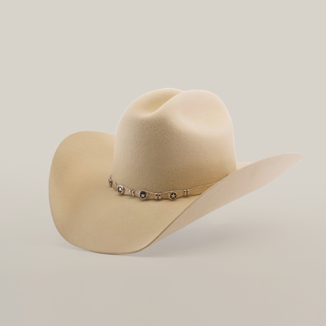 The 6X Country Bone, a beige felt cowboy hat made from soft sheep wool, is decorated with a metal concho band. This Western classic features a wide brim and pinched crown, elegantly set against a plain white background.