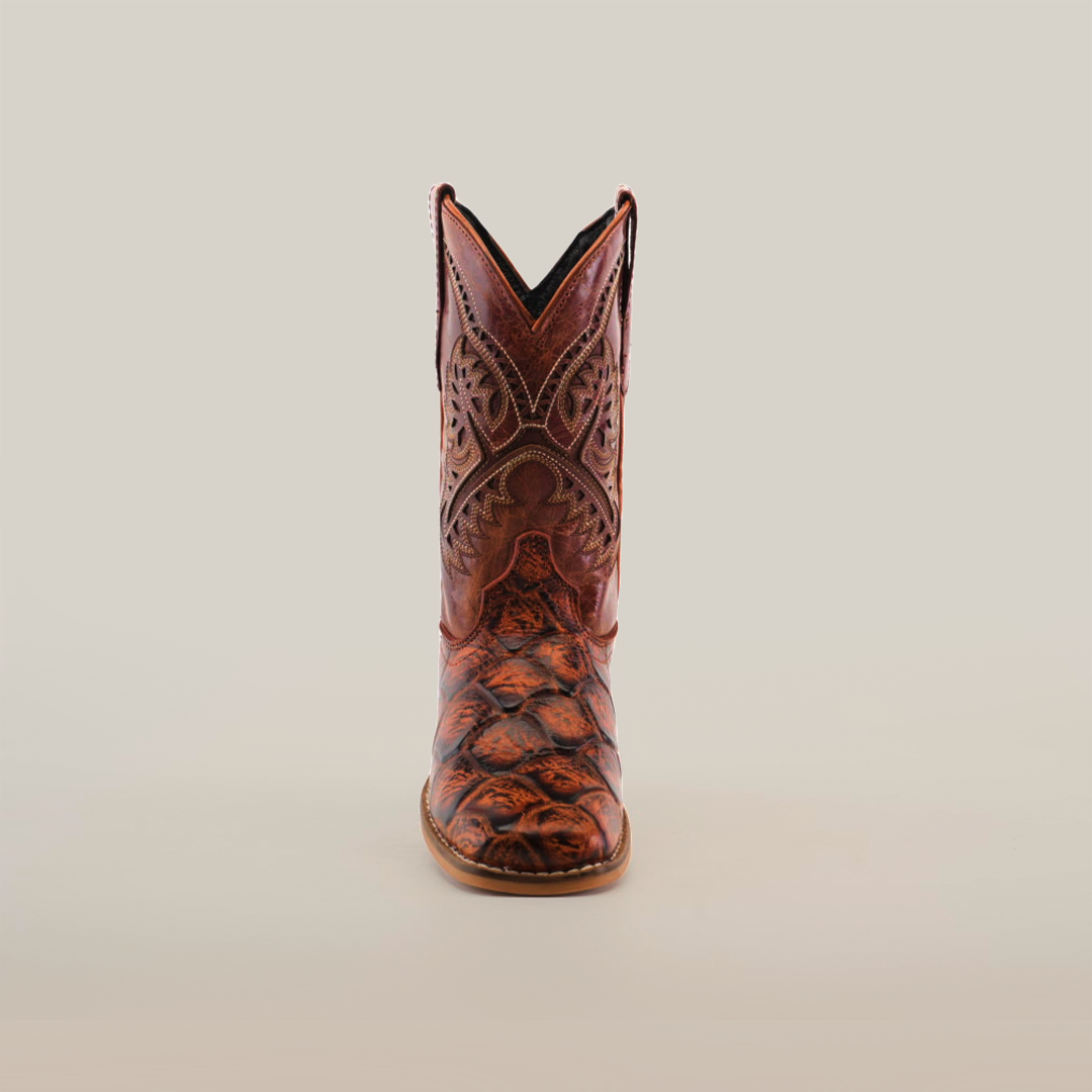 The Pirarucu Bass Print Cognac Square Toe boot, crafted from premium brown leather with intricate stitching and design, is viewed from the front. It features a distinctive square toe and is displayed against a plain white background.