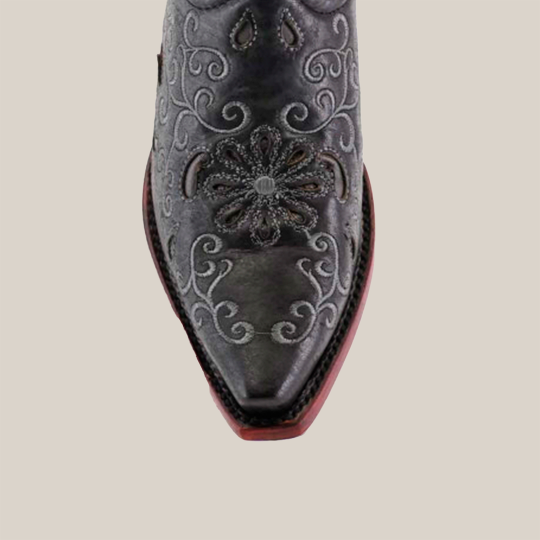 A close-up of the Alessandria Black Mid Shaft boots snip toe reveals intricate floral and scroll embroidery on premium leather, highlighted elegantly against a plain white background.