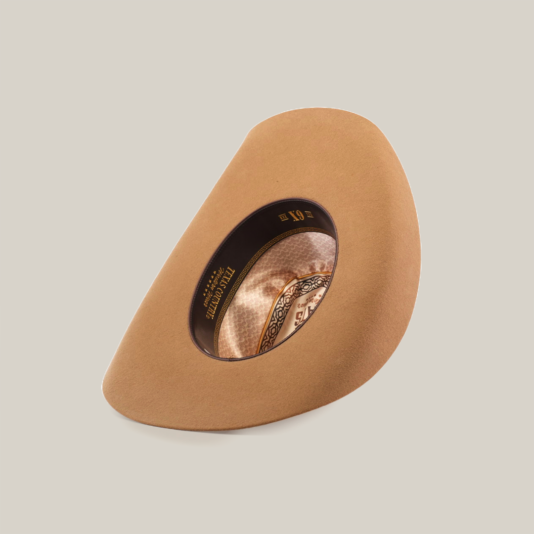 The 6X Chihuahua Fawn is a brown Western hat made from premium sheep wool, featuring an oval opening and intricate inner band designs, set against a white background.