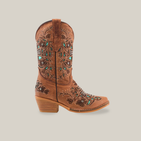 The Alamo Studs Honey -+ Snip Toe is a brown cowboy boot made from cowhide leather, featuring detailed turquoise and black floral and geometric embroidery. It has a short heel and is presented on a plain white background.