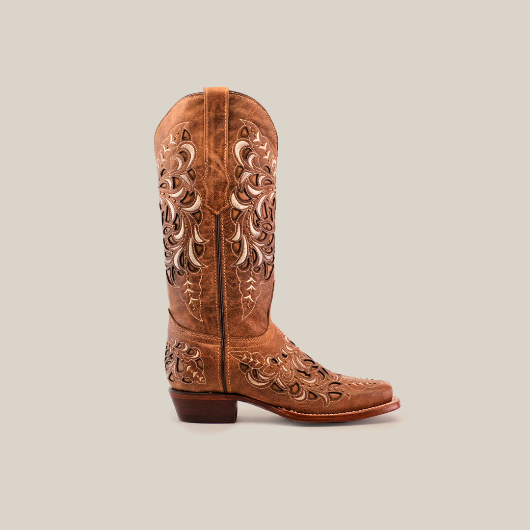 The Kiara Crystals Fawn is a brown cowboy boot made from premium leather. It features intricate embroidery and Kiara Crystals on the shaft and foot, paired with a narrow square toe and low heel against a plain white background.