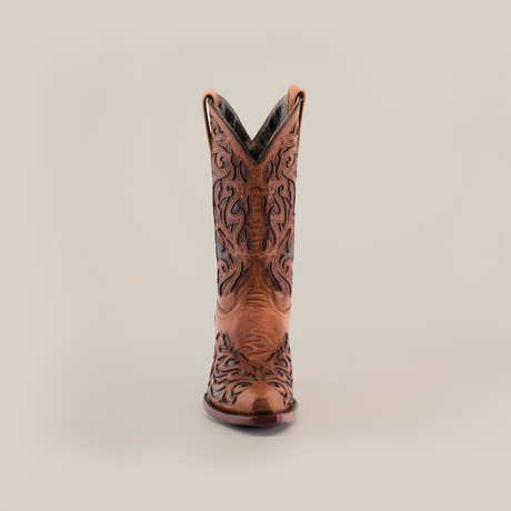 The Trivia Orix womens boot, in premium brown leather with intricate black embroidery, is showcased against a white background. This handcrafted boot features a snip toe and short shaft, highlighting its elegant decorative patterns.