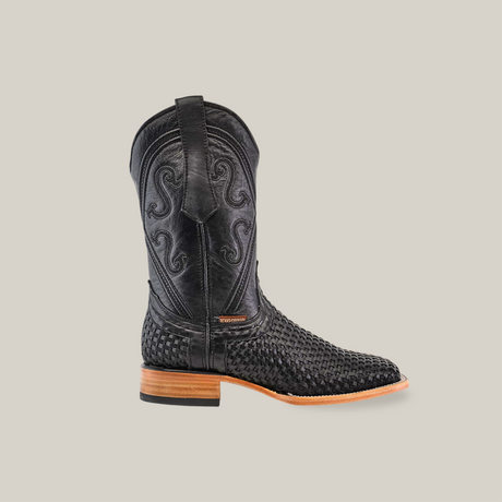 The Texas Basket Weave Black - Square Toe cowboy boot features intricate swirl patterns on the shaft and a woven cowhide leather texture on the foot, finished with a wooden heel and light sole.